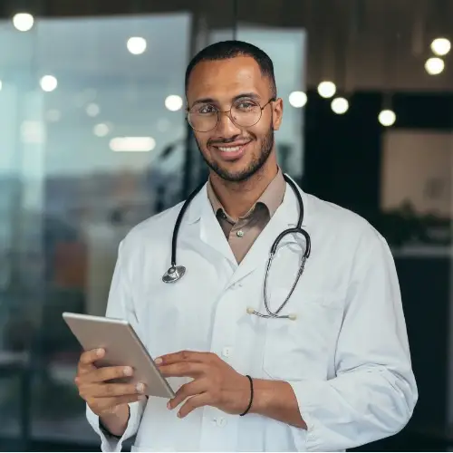 portrait of happy and successful african american doctor man working inside office